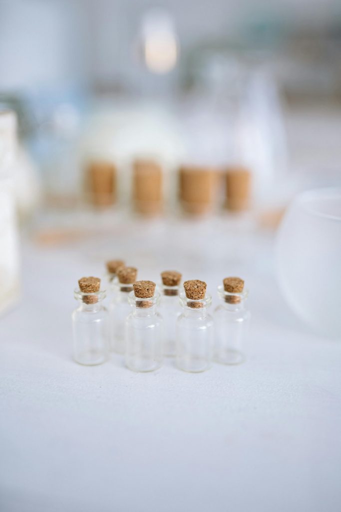 A still life photo showcasing an artistic arrangement of small glass bottles with cork stoppers, perfect for crafts or decoration.
